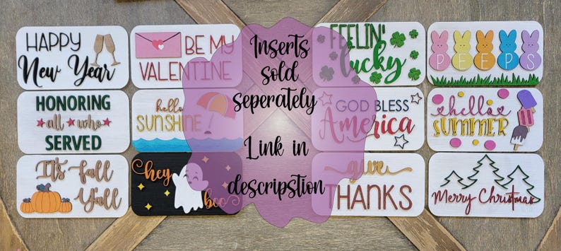 May include: A collection of 12 wooden signs with various holiday and seasonal themes. The signs feature phrases like "Happy New Year", "Be My Valentine", "Feeling Lucky", "God Bless America", "It's Fall Y'all", and "Merry Christmas".