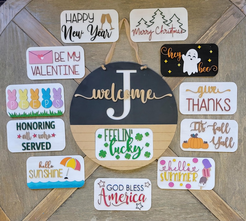 May include: A collection of 12 wooden signs with various holiday and seasonal greetings. The signs are painted in different colours and feature festive designs, such as a ghost, a snowman, a shamrock, and a pumpkin. The signs are perfect for decorating a home or business for any occasion.