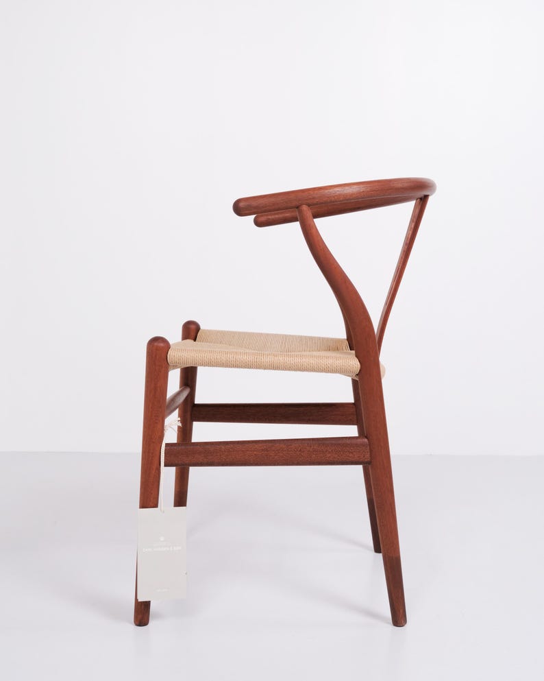 May include: A wooden chair with a woven seat and a curved backrest. The chair is made of dark wood and has a light-colored woven seat. The chair is a classic design, suitable for dining or as an accent piece.