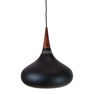 May include: A black pendant light with a wooden top and gold accents. The light has a teardrop shape.