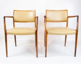 A pair of N.O. Moeller armchairs, model 65, in rosewood and light leather manufactured by J.L. Moeller in the late 1960s