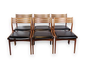 May include: Set of six mid-century modern dining chairs with black vinyl seats and wood frames.