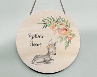 A 20cm wooden wall hanging featuring a deer, flowers and personalised details.  Matching cards also available. Handmade in Australia.