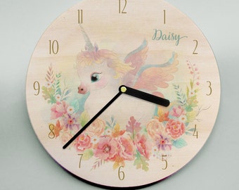 Child's name clock with unicorn and flowers in pastel pinks, blues, greens and purples on wooden clockface