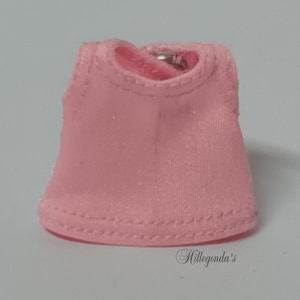 May include: A pink sleeveless top with a double stitched hem.