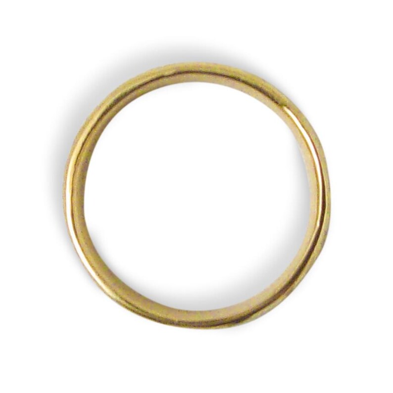 May include: A gold-colored ring with a smooth, rounded band. The ring is set against a white background, highlighting its simple, elegant design. This piece of jewelry is suitable for everyday wear.