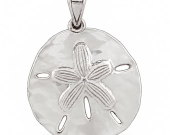 May include: A silver-toned pendant shaped like a sand dollar, featuring a central five-pointed star pattern with textured, hammered surfaces and five small, elongated cutouts arranged around the perimeter, topped with a polished bail.