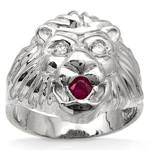 May include: A silver lion ring with a ruby gemstone in its mouth. The ring has a detailed design of the lion's face, with two small gemstones for eyes. The ring is a bold statement piece.