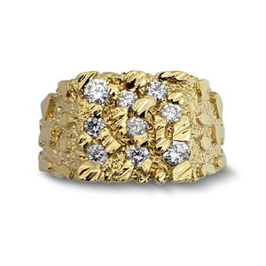 May include: A gold ring featuring a textured, nugget-style band with a wide, rectangular face. The surface of the ring is embedded with nine round, clear, faceted stones arranged in a grid pattern across the irregular, metallic gold surface.