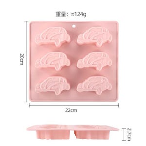 May include: Pink silicone mold with six car-shaped cavities. The mold measures 22 cm by 20 cm.  The weight of the mold is approximately 124 grams.