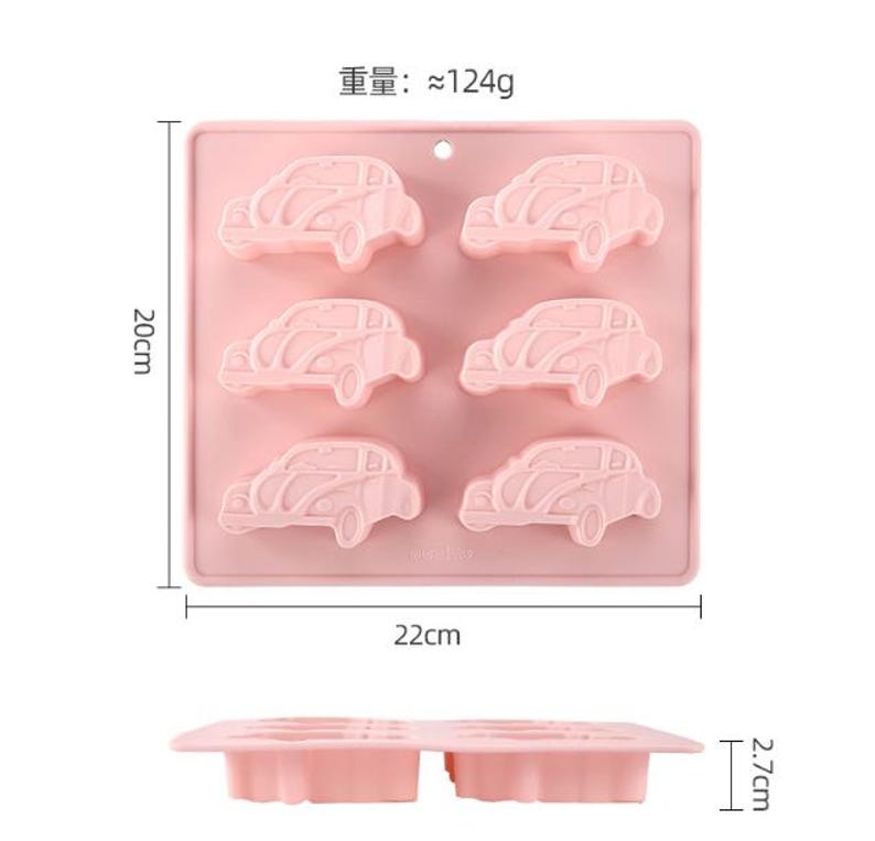 May include: Pink silicone mold with six car-shaped cavities. The mold measures 22 cm by 20 cm.  The weight of the mold is approximately 124 grams.