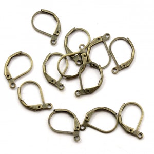 May include: A group of 12 antique brass earring hooks, also known as ear wires, for jewelry making. The hooks are made of metal and have a spring-loaded clasp.