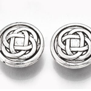 May include: A pair of silver-toned earrings with a Celtic knot design.