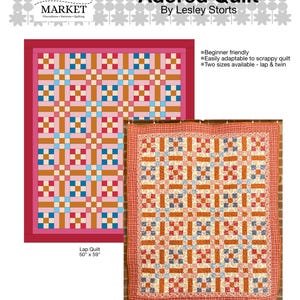 May include: A colorful quilt pattern with the text "Adored Quilt" by Lesley Storts. The quilt features a geometric design in shades of pink, orange, blue, and white. The lap quilt measures 50" x 59".