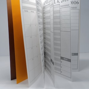 May include: A black and white calendar planner with the month of April 2016. The calendar has a daily planner section with a menu section.