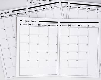 May include: Several open white paper calendars, each displaying the month of June 2017. The calendars have a simple design with black lines and text, including days of the week and dates.