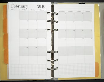 May include: A white monthly planner with a gray grid pattern. The planner is open to February 2016. The planner has a silver binding with six rings.