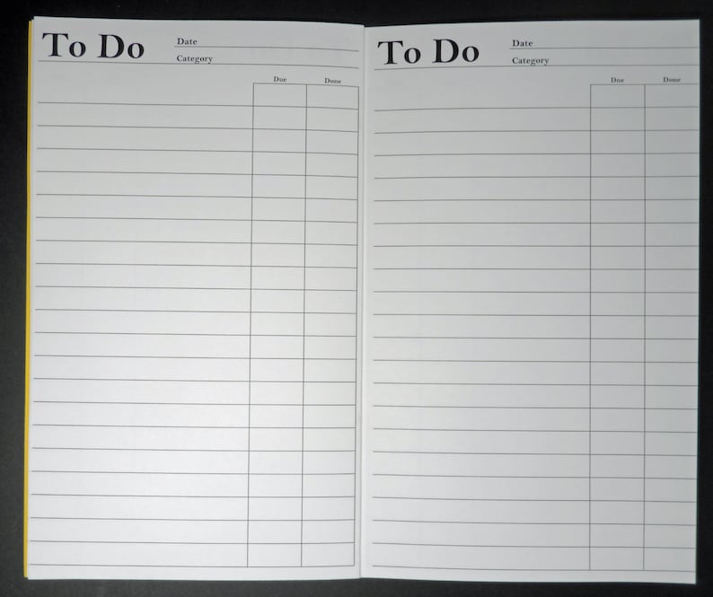 May include: A white to-do list notebook with a yellow spine. The notebook is open to two blank pages with lined paper. The pages are labeled "To Do" with columns for "Date" and "Category".