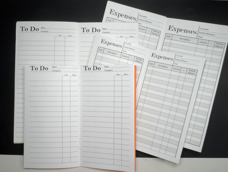 May include: A set of six blank notebooks, four labeled "Expenses" and two labeled "To Do". The notebooks are white with black lines and headings.