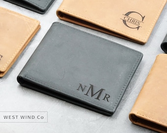 May include: Four leather wallets with personalized initials. The wallets are brown and black. The text "WEST WIND CO" is visible at the bottom of the image.