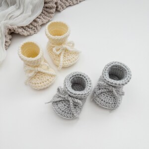 May include: A set of three ceramic mugs with a speckled, matte finish. The mugs are in shades of cream, light gray, and dark gray. Each mug has a simple, minimalist design, perfect for coffee or tea.