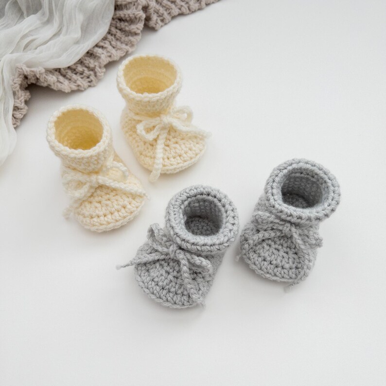 May include: A set of three ceramic mugs with a speckled, matte finish. The mugs are in shades of cream, light gray, and dark gray. Each mug has a simple, minimalist design, perfect for coffee or tea.