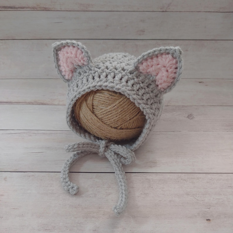 This sweet little baby kitty bonnet is hand crocheted by me. Made to order with soft acrylic yarn, our little baby kitten bonnet is the perfect accessory to keep your little one warm during those cold winter months.