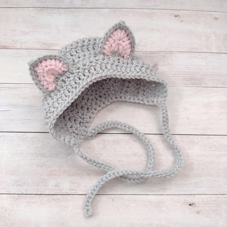 This sweet little baby kitty bonnet is hand crocheted by me. Made to order with soft acrylic yarn, our little baby kitten bonnet is the perfect accessory to keep your little one warm during those cold winter months.