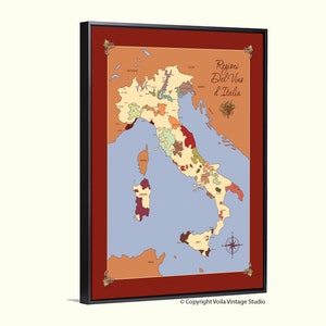 May include: A vintage-style map of Italy showing the wine regions. The map is printed on a canvas and framed in a black frame with a red mat. The title of the map is "Regioni Del Vino d'Italia".