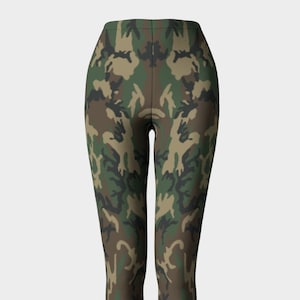 May include: Camouflage print leggings in shades of green, brown, and black. The leggings have a high waist and a fitted silhouette.