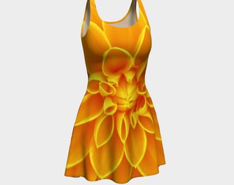 May include: A sleeveless orange dress with a large yellow flower print. The dress has a fitted bodice and a flared skirt.
