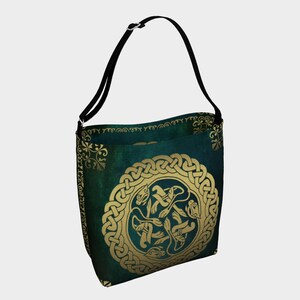 The Buschwacked matching Tote Bag is shown. A green and gold neoprene bag with the same Celtic knot-like  design. The bag has a black shoulder strap.