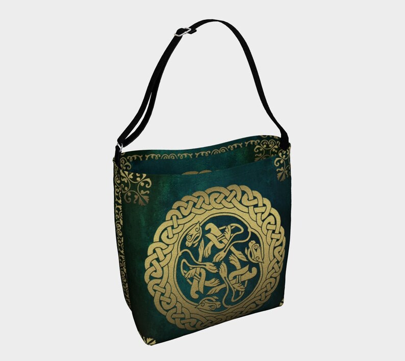 The Buschwacked matching Tote Bag is shown. A green and gold neoprene bag with the same Celtic knot-like  design. The bag has a black shoulder strap.