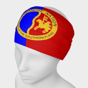 May include: A red and blue headband with a yellow circle containing a black silhouette of a rider on horseback. The circle has the text "Comanche Nation Lords of the Southern Plains".
