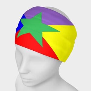 May include: A headband with a purple, yellow, red, and blue design featuring a green five-pointed star.