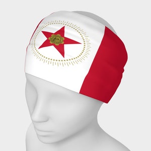May include: A white headband with a red stripe and a gold star in a circle on the left side. The star has a gold gear in the center.