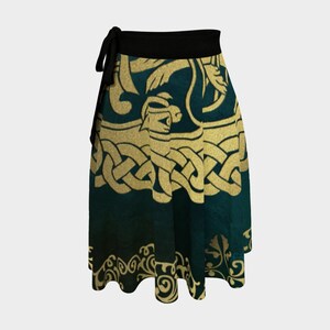 The Buschwacked matching wrap skirt is shown. A green and gold skirt with the same Celtic knot-like  design. The skirt has a black waistband/sash that ties at the side.