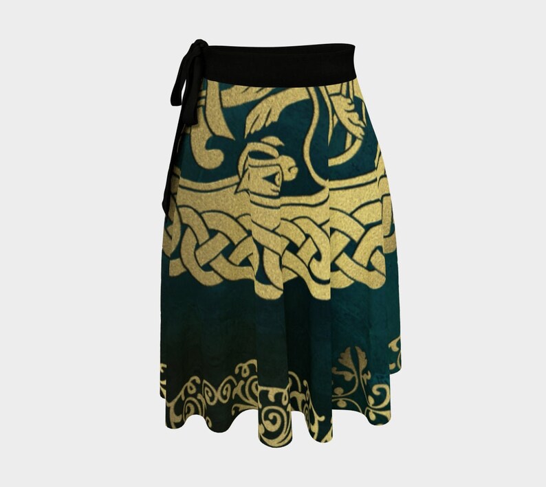 The Buschwacked matching wrap skirt is shown. A green and gold skirt with the same Celtic knot-like  design. The skirt has a black waistband/sash that ties at the side.