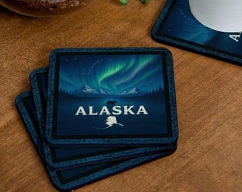 Alaska State Coaster Set of 4 featuring an Alaskan mountain scene, the Aurora Borealis, the Big Dipper, and the North Star