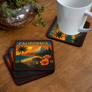 May include: A stack of square coasters with a California theme. Each coaster features a scenic illustration of a coastal road, palm trees, and a sunset. The coasters have a dark brown border and the word "CALIFORNIA" at the top.