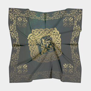 The backside of this green and gold patterned scarf is displayed to show that the Celtic knot design is shows on the back but is slightly muted.