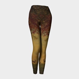 May include: High-waisted leggings featuring a colourful autumn forest scene with a family of deer at the bottom. The leggings have a gradient design with red, orange and yellow hues.