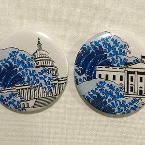 May include: Two round white buttons with blue and white images. The first button shows the US Capitol building with a large wave crashing over it. The second button shows the White House with a large wave crashing over it.
