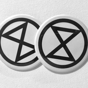 May include: Two white round buttons with a black circle and a black anarchy symbol inside.