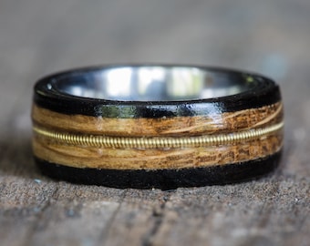 Tennessee Whiskey Barrel, Ebony, and Titanium Ring with Brass Guitar String Inlay