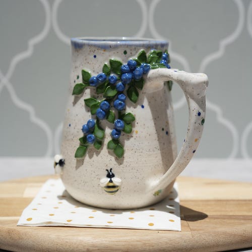 Handmade Ceramic Blueberry And Bee Mug: Blue Glazed Stoneware