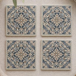 May include: A set of four square coasters featuring a symmetrical, intricate mandala-style pattern in shades of navy blue, slate grey, and cream. Each coaster displays a central floral motif surrounded by detailed geometric and scrollwork borders.