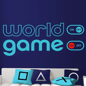 May include: A white couch with three blue pillows featuring the PlayStation controller symbols. The wall behind the couch is painted blue and has a blue and white decal that reads "world game" with two toggle switches that read "ON OFF".