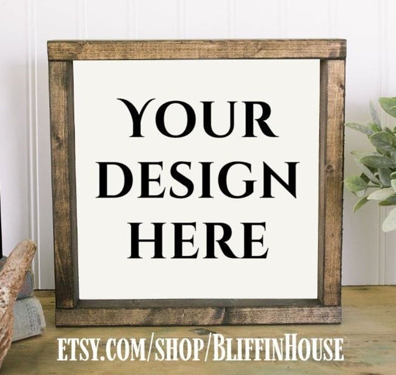 May include: A wooden sign with a white background and black text that reads "YOUR DESIGN HERE". The sign is in a rustic brown frame. The text "ETSY.COM/SHOP/BLIFFINHOUSE" is at the bottom of the sign.