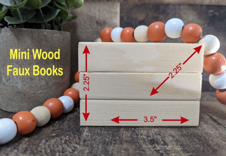 May include: Three stacked wooden blocks, each measuring 2.25 inches by 3.5 inches, with the text "Mini Wood Faux Books" printed on the left side.